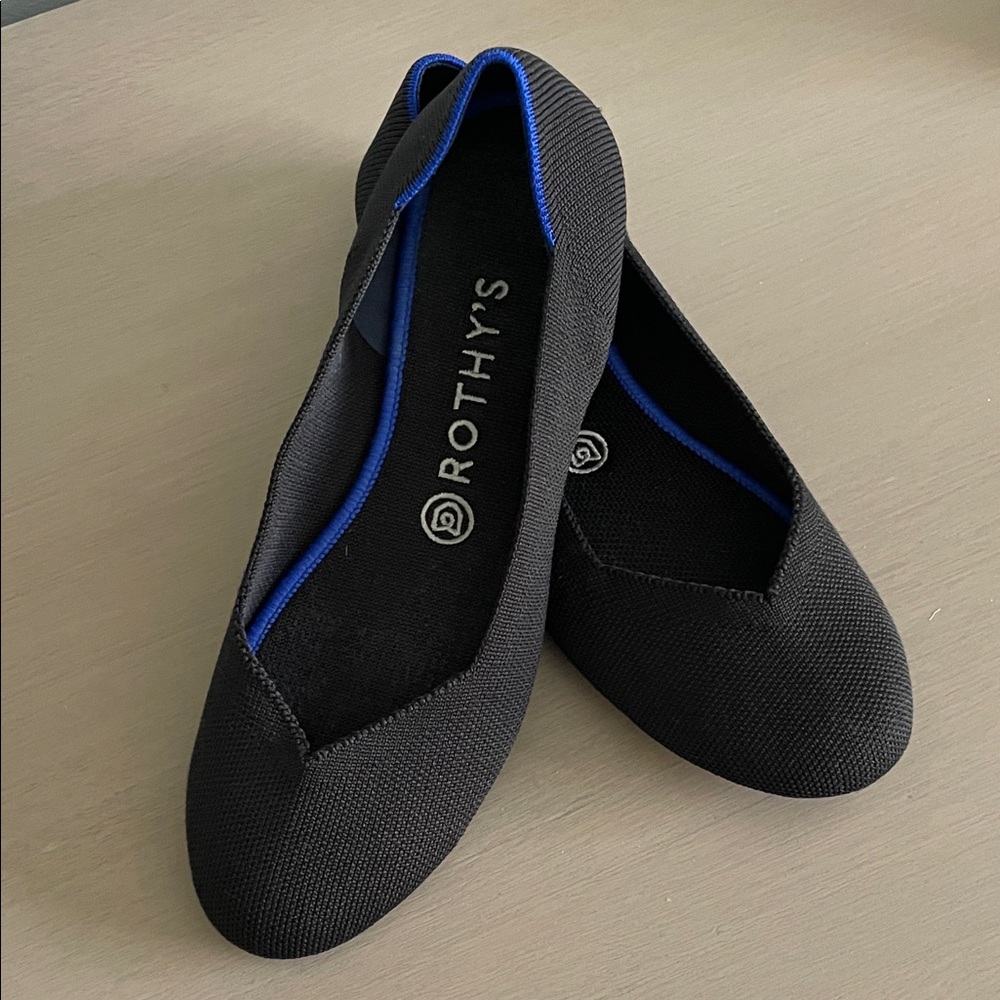 Rothy's Elegant Black Flats with Vibrant Blue Accent